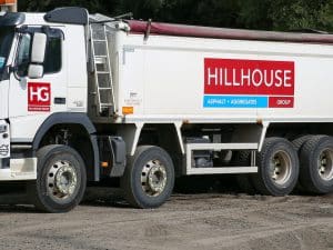 Large white industrial truck with multiple wheels, displaying Hillhouse Group asphalt branding.