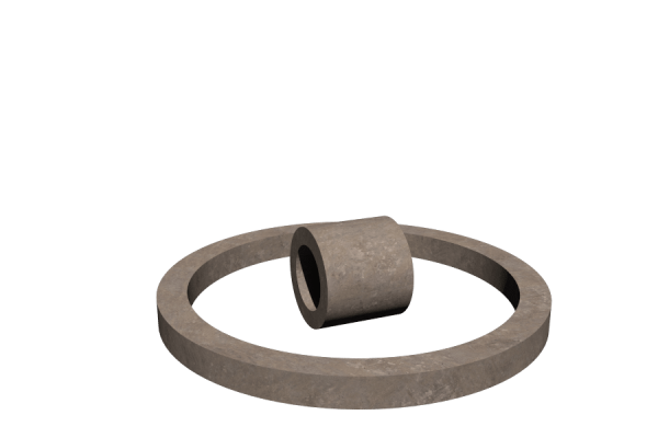 Thick concrete ring lying flat with a short hollow stone cylinder inside on a dark background